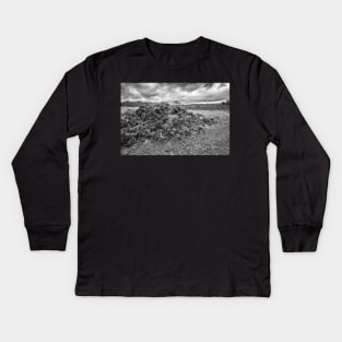 Muck heap in an arable field in the English countryside Kids Long Sleeve T-Shirt